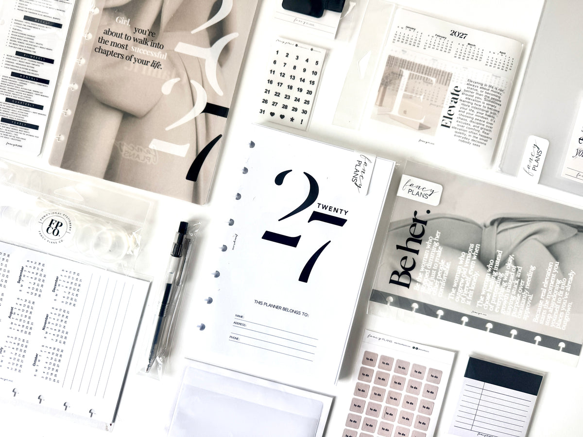 Planner box pages and stationery arranged on a tabletop